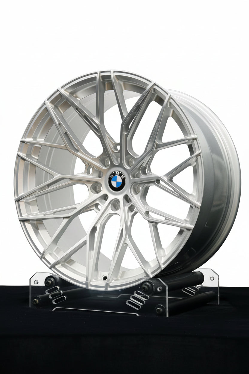 Custom forged WheelWorkCustoms WWC Vector Mesh wheels on a vehicle, showcasing their intricate mesh design and sleek metallic finish.