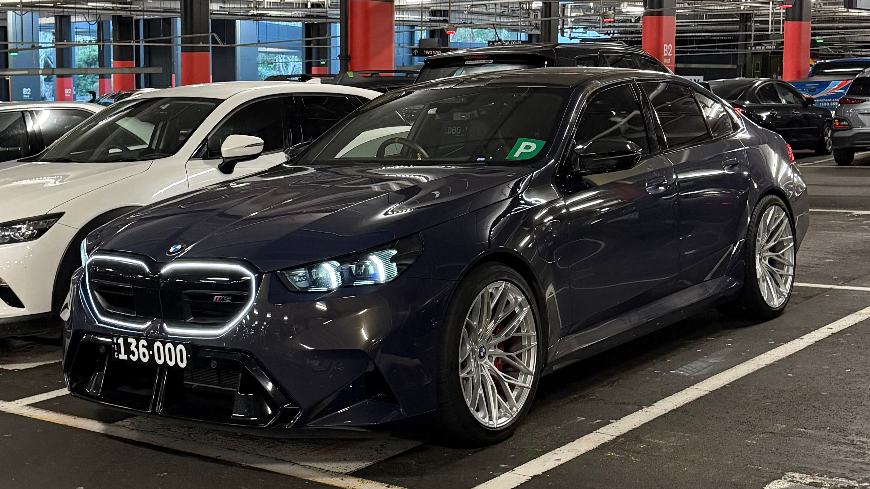 Custom forged WWC Vector Mesh wheels by WheelWorkCustoms showcasing their detailed multi-spoke design and sleek finish.